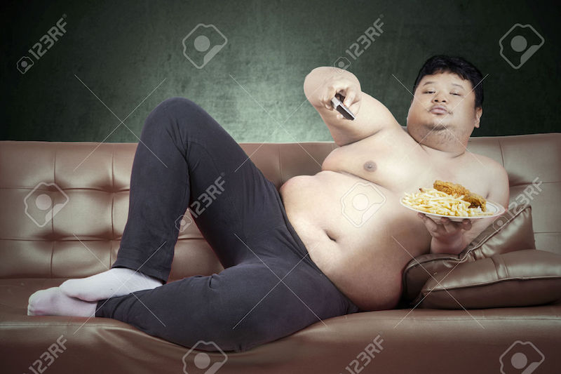 37961133-Fat-man-eats-fast-food-while-watching-tv-at-home-Stock-Photo-couch.jpg