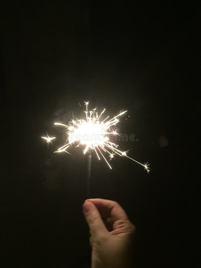 celebrate-new-year-hand-little-firework-99987467.jpg