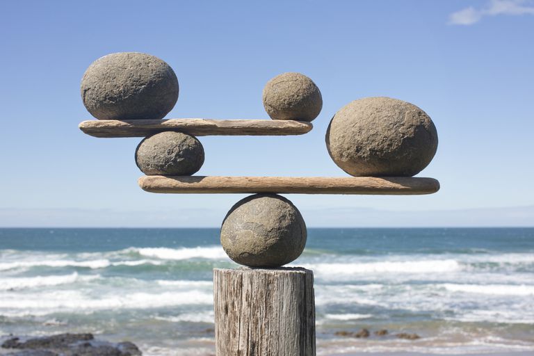 rocks-balancing-on-driftwood--sea-in-background-153081592-591bbc3f5f9b58f4c0b7bb16.jpg