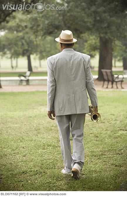 senior_african_man_walking_with_trumpet_BLD071162.jpg