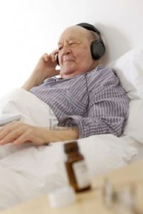 6874020-old-man-listening-to-music-while-lying-in-bed-at-home.jpg